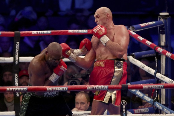 Tyson Fury, right, lands a punch during his WBC heavyweight championship boxing match against Derek Chisora at Tottenham Hotspur's White Hart Lane stadium London, Saturday Dec. 3, 2022.(AP Photo/Ian W ...