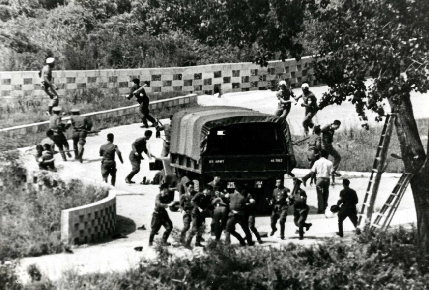 FILE - In this Aug. 18, 1976 file photo, North Korean soldiers attack United Nations Command personnel wearing helmets at the truce village of Panmunjom, South Korea. The summit between the leaders of ...