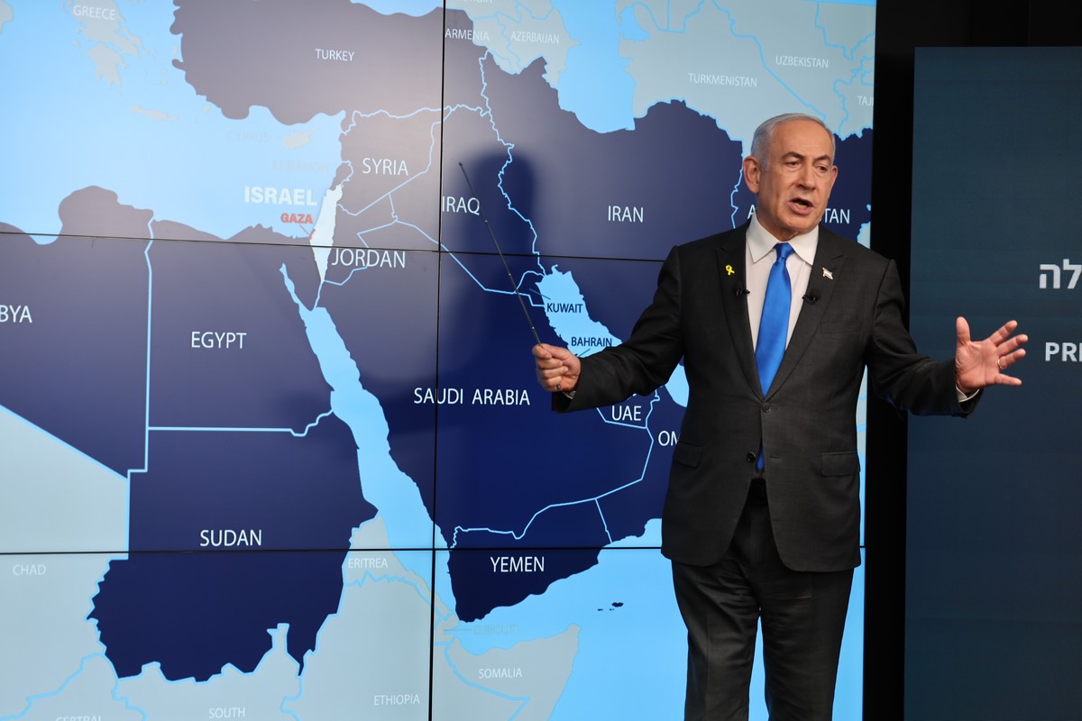 epa11584985 Israeli Prime Minister Benjamin Netanyahu stands before a map of the Middle East , during a press conference for the international media at the Government Press office in Jerusalem, 04 Sep ...