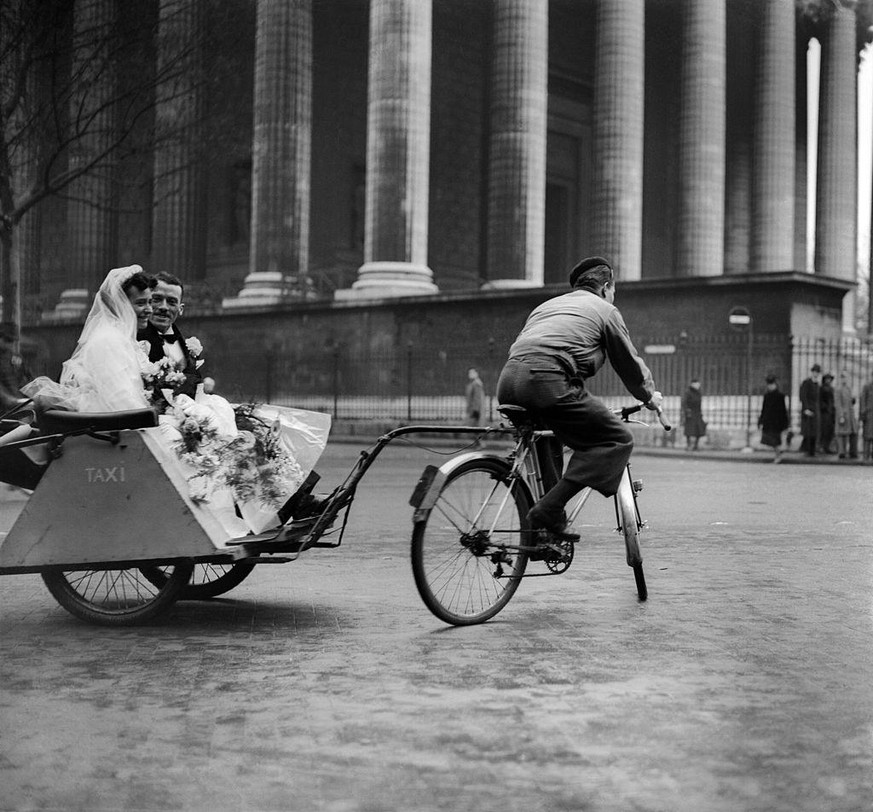 World War II, Wedding on a cycle taxi, at the place de la Madeleine, Paris, December 1941. (Photo by Roger Viollet via Getty Images/Roger Viollet via Getty Images)