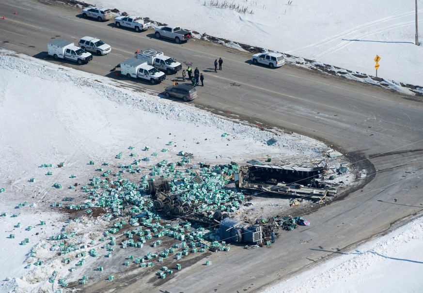 Emergency personnel work at the scene of a fatal crash outside of Tisdale, Saskatchewan, Canada, Saturday, April, 7, 2018. A bus en route to Nipawin, front right, carrying the Humbolt Broncos junior h ...