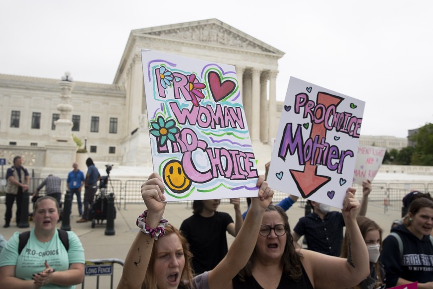 epa09926804 Abortion rights advocates hold signs outside the Supreme Court in Washington, DC, USA, 04 May 2022. The Supreme Court is prepared to overturn Roe v. Wade, the landmark ruling that for near ...