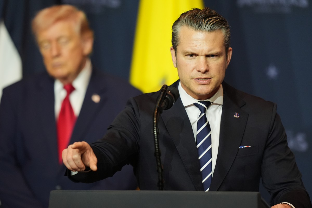 Defense Secretary Pete Hegseth speaks while President Donald Trump, left, listens at the Shield of the Americas Summit, Saturday, March 7, 2026, at Trump National Doral Miami in Doral, Fla. (AP Photo/ ...