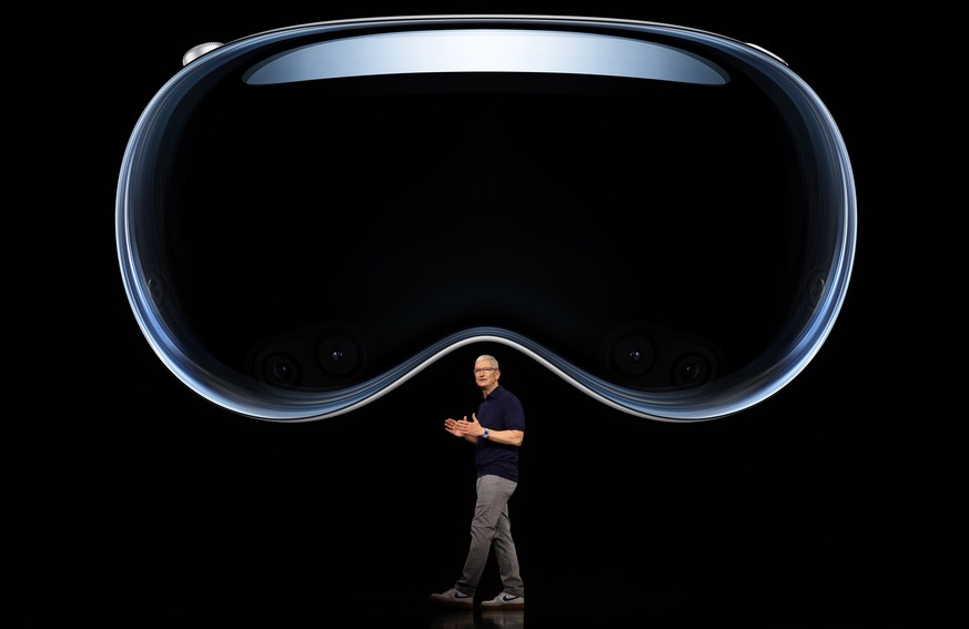 epa10675042 A handout photo made available by Apple showing Apple CEO Tim Cook introducing the Apple Vision Pro during the keynote address for the 2023 Apple Worldwide Developers Conference (WWDC) on  ...