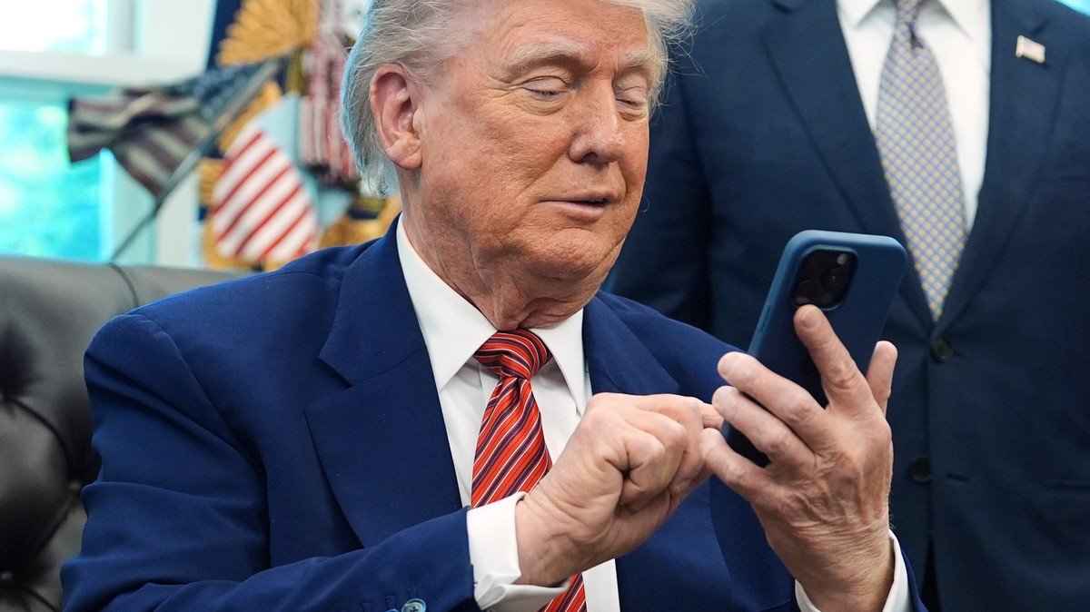 FILE - President Donald Trump silences his mobile phone in the Oval Office of the White House, May 23, 2025, in Washington. (AP Photo/Evan Vucci, File)
Donald Trump