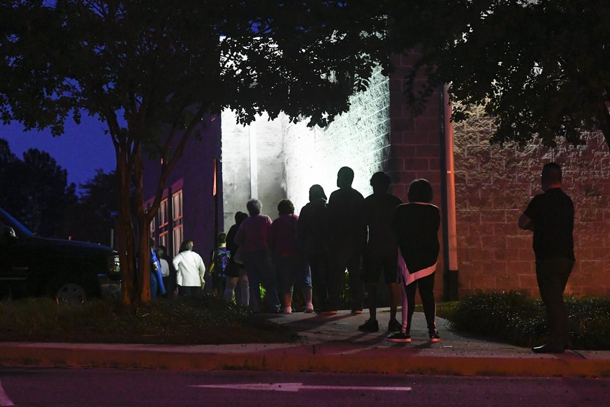 epa08738304 A line is formed before dawn as the first day of early voting gets underway at the Mountain Park Activity Building in Stone Mountain, Georgia, USA, 12 October 2020. EPA/ATLANTA JOURNAL CON ...