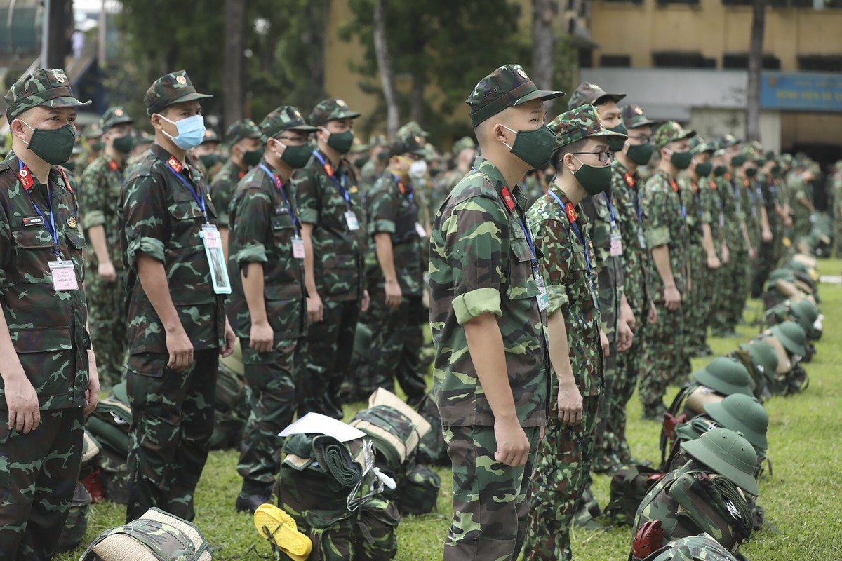 Army soldiers line up during a ceremony to send off military doctors to Ho Chi Minh City to help with treating COVID-19 patients in Hanoi, Vietnam, Monday, Aug. 23, 2021. Vietnam's largest metrop ...