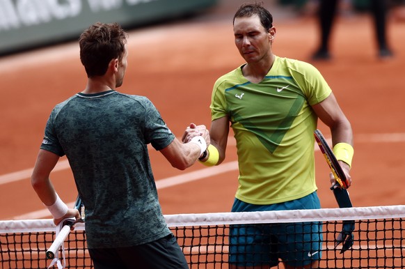epa09997677 Rafael Nadal of Spain (R) reacts with Casper Ruud of Norway after winning their Men?s Singles final match during the French Open tennis tournament at Roland ?Garros in Paris, France, 05 Ju ...
