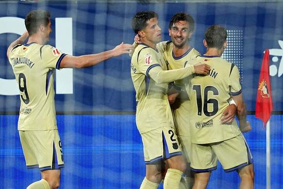 Barcelona's Ferran Torres, second right, celebrates after scoring his side's second goal during a Spanish La Liga soccer match between Osasuna and Barcelona in Pamplona, Spain, Saturday, May ...