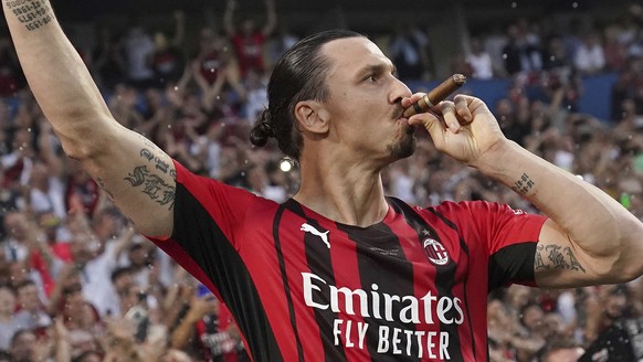 AC Milan&#039;s Zlatan Ibrahimovic puffs a cigar as he celebrates after winning a Serie A soccer match between AC Milan and Sassuolo, in Reggio Emilia&#039;s Mapei Stadium, Italy, Sunday, May 22, 2022 ...