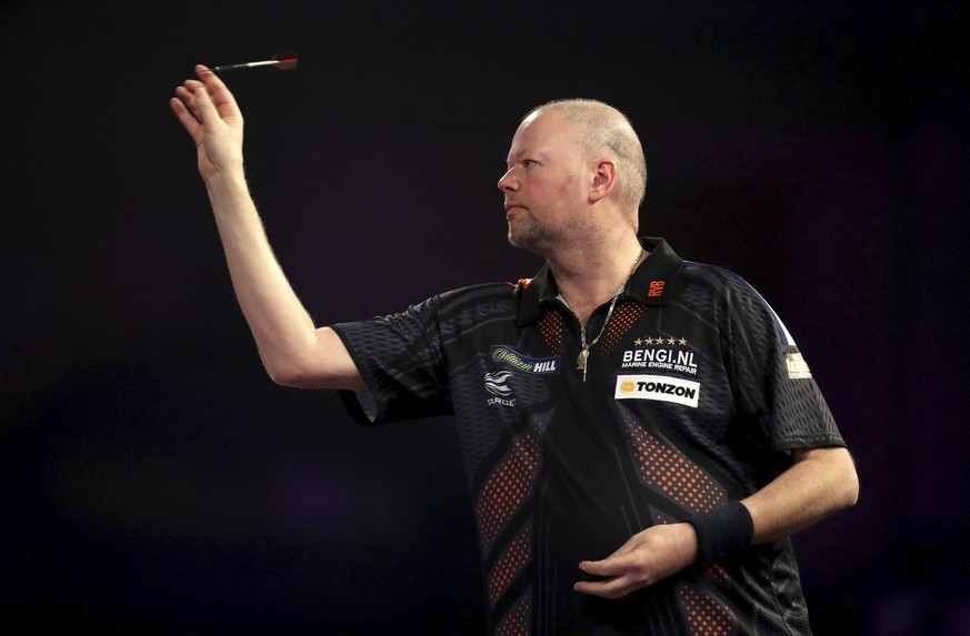 Raymond van Barneveld of the Netherlands throws a dart during his quarterfinal match against fellow countryman Michael van Gerwen on day thirteen of the World Darts Championship at Alexandra Palace, L ...