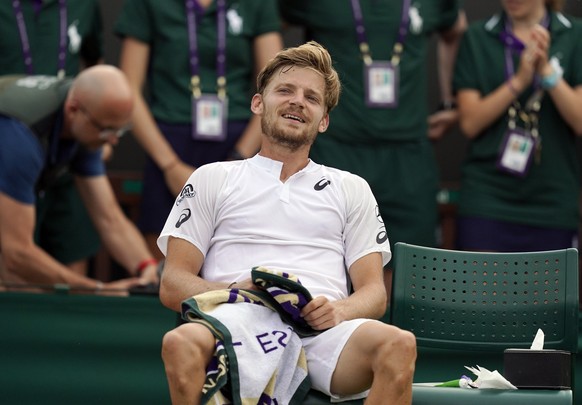 epa07697667 David Goffin of Belgium celebrates his win over Daniil Medvedev of Russia in their third round match during the Wimbledon Championships at the All England Lawn Tennis Club, in London, Brit ...