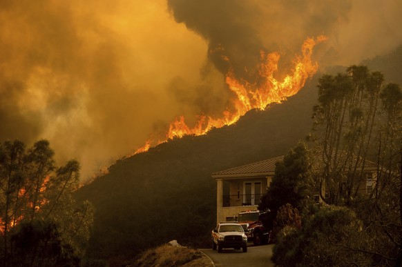 FILE - In this Monday, Aug. 17, 2020 file photo, flames from the River Fire crest a ridge in Salinas, Calif. In California, a Mediterranean climate sets up ideal conditions for fire then is worsened b ...