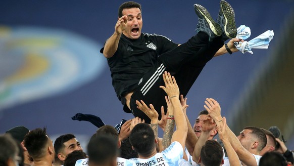 RIO DE JANEIRO, BRAZIL - JULY 10: Players of Argentina lift in the air their Head Coach Lionel Scaloni after winning the Final of Copa America Brazil 2021 ,during the Final Match between Brazil and Ar ...