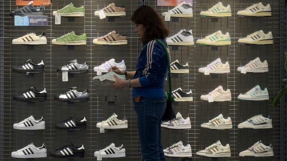 A woman tries out a shoe at an Adidas sportswear store inside a shopping mall, in Beijing, Saturday, April 12, 2025. (AP Photo/Andy Wong)
China Trump Tariffs