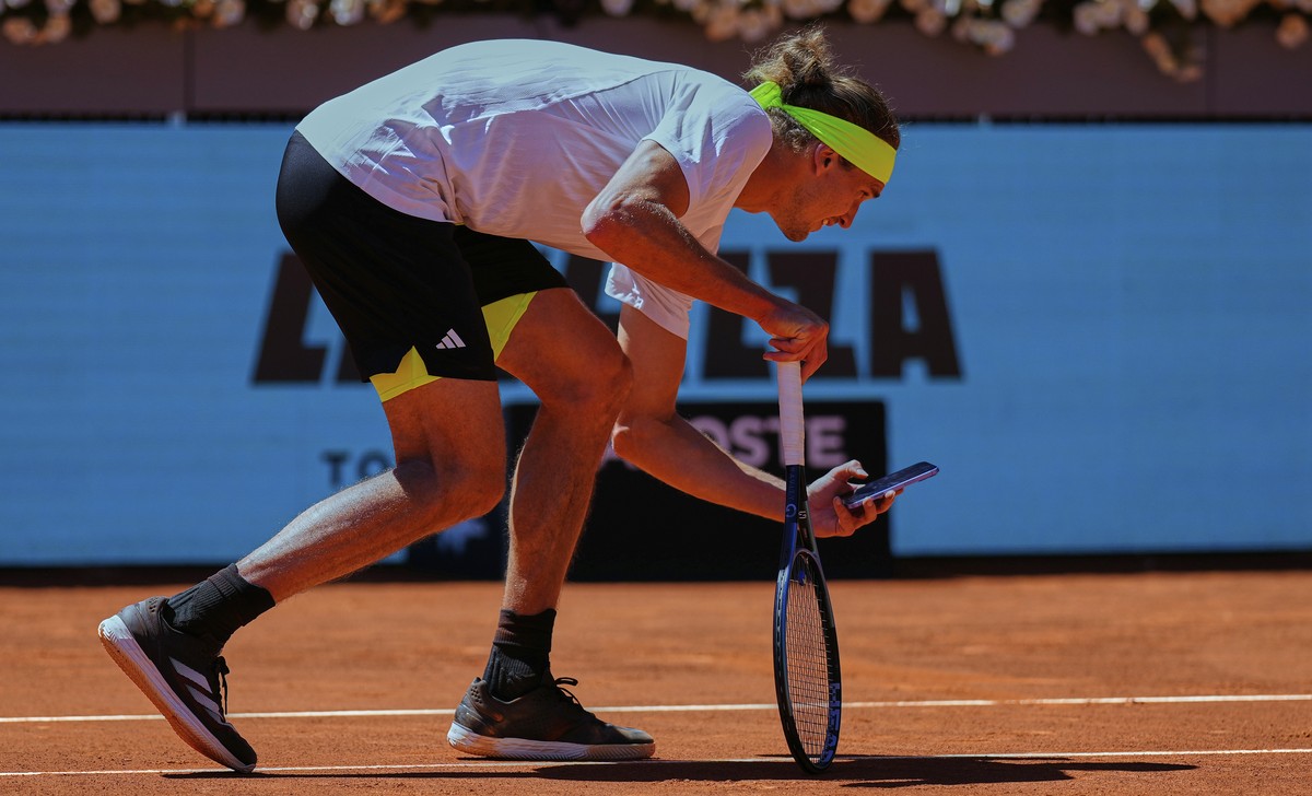 Alexander Zverev of Germany takes a picture with his phone during his Madrid Open round of 32 tennis match against Alejandro Davidovich Fokina of Spain, in Madrid, Spain, Sunday, April 27, 2025. (AP P ...