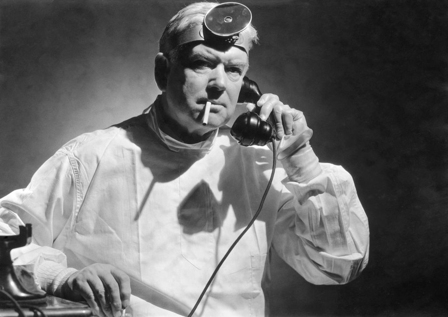 A doctor smoking a cigarette while taking a phone call, circa 1950. (Photo by FPG/Hulton Archive/Getty Images)