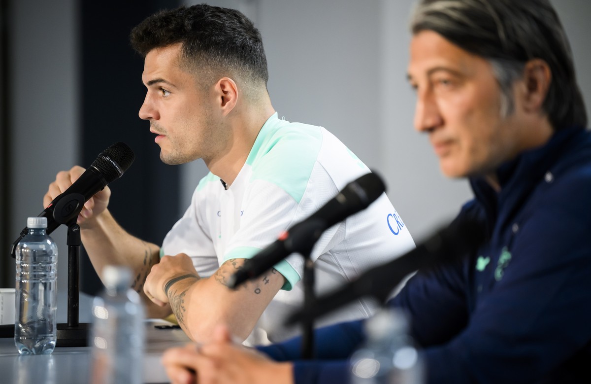 epa10007830 Switzerland's midfielder Granit Xhaka, left, and Switzerland's head coach Murat Yakin, right, speak during a a press conference on the eve of the UEFA Nations League group A2 soc ...