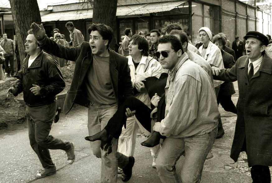 Picture made April 5, 1992 shows Sarajevans carrying Olga Sucic, one of the first victims of the Bosnian 1992-95 war, in downtown Sarajevo. During the country's war that began 10 years ago betwee ...