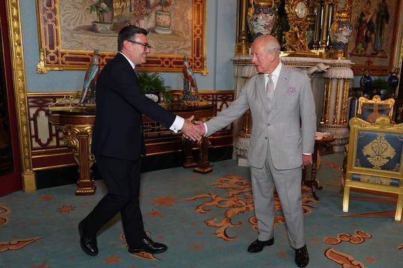 Britain's King Charles III welcomes Andy Burnham, left, during an audience at Buckingham Palace, London, where he invited the leader of the Labour Party to become Prime Minister and form a new go ...