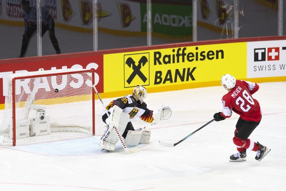 Switzerland's forward Timo Meier, right, scores a goal against Germany's goaltender Mathias Niederberger, left, during the shootout session, at the IIHF 2021 World Championship quarter final game betw ...