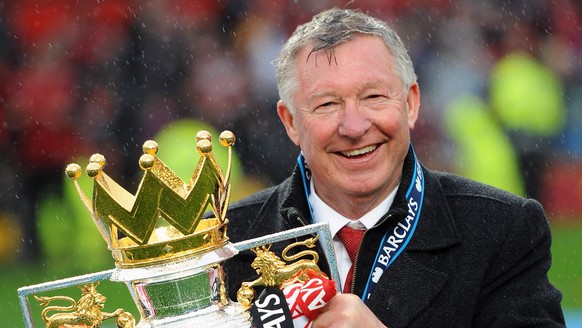 epa06713858 (FILE) Manchester United manager Sir Alex Ferguson lifts the English Premier League trophy after the English Premier League soccer match between Manchester United and Swansea City at Old T ...