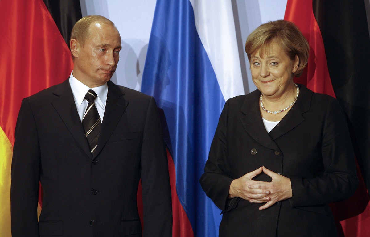 FILE - German Chancellor Angela Merkel, right, and Russian President Vladimir Putin hold a news conference after bilateral talks in Dresden, on Oct. 10, 2006. Merkel has been credited with raising Ger ...