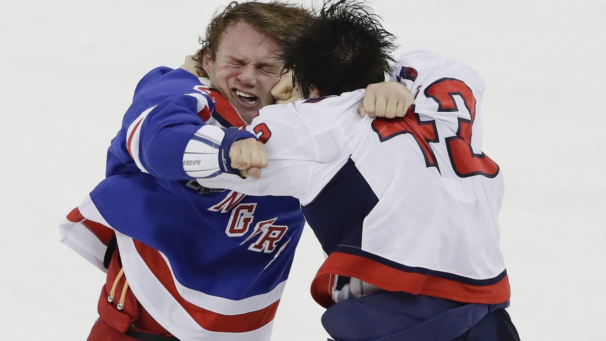 New York Rangers' Brendan Lemieux, left, is punched by Washington Capitals' Tom Wilson (43) during the third period of an NHL hockey game Wednesday, Nov. 20, 2019, in New York. The Rangers w ...