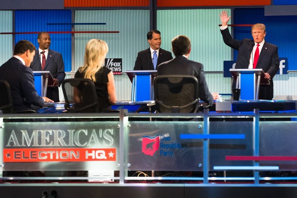 Republican presidential candidate Donald Trump, right, speaks to moderators from left foreground, Bret Baier, Megyn Kelly and Chris Wallace during the first Republican presidential debate at the Quick ...