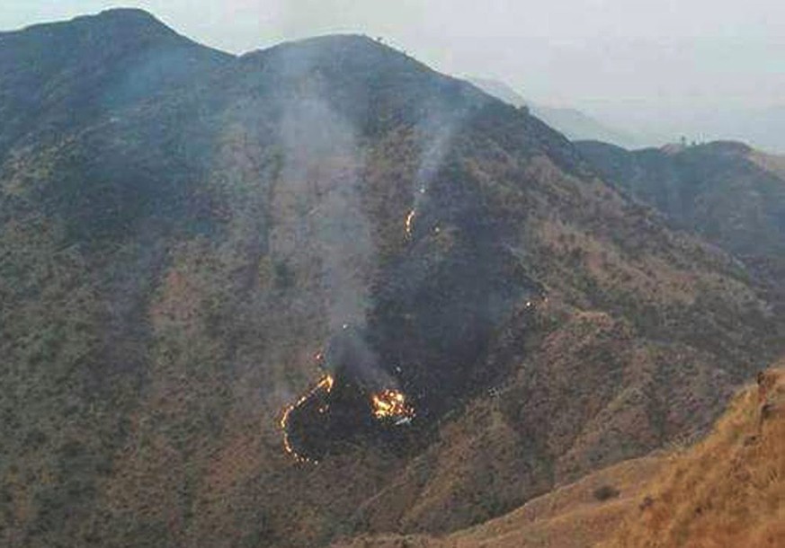 epa05663827 Flames rise from the wreckage of a Pakistan International Airlines (PIA) ATR 42 turboprop passenger plane after it crashed near Abbottabad,Pakistan, 07 December 2016. A Pakistan Internatio ...