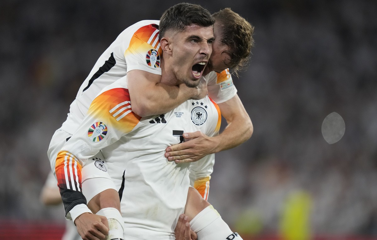 Germany's Kai Havertz celebrates with Joshua Kimmich after scoring his side's third goal during a Group A match between Germany and Scotland at the Euro 2024 soccer tournament in Munich, Ger ...