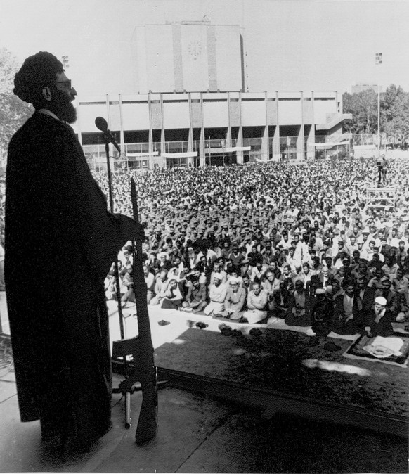 Ayatollah Khamenei leans on an assault weapon as he gives a sermon and report on the war during prayers in Teheran, Iran, Oct. 11, 1980. He said the morale of Iranian soldiers was high. Libya is repor ...