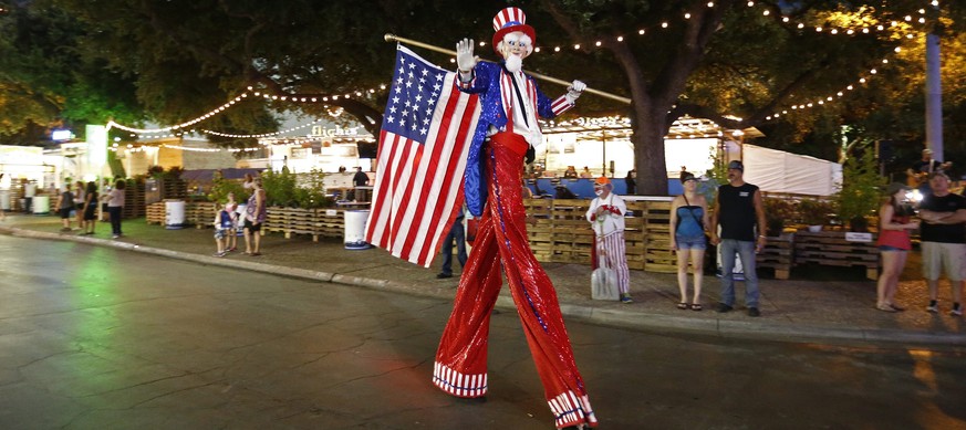 epa05572156 A man on stilts dressed as Uncle Sam walks along during a parade at the State Fair of Texas in Dallas, Texas, USA, 05 October 2016. The annual State Fair of Texas has taken place nearly ev ...