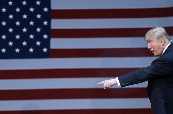 President Donald Trump points to the crowd after a rally in Pensacola, Fla., Friday, Dec. 8, 2017. (AP Photo/Jonathan Bachman)