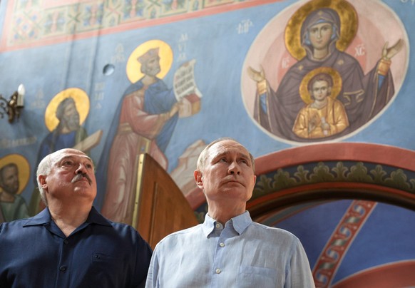 epa12277224 Russian President Vladimir Putin (R) and Belarusian President Alexander Lukashenko attend a service at the Church of the Our Lady of Smolensk Icon at the Smolensky Skete of the Savior Tran ...
