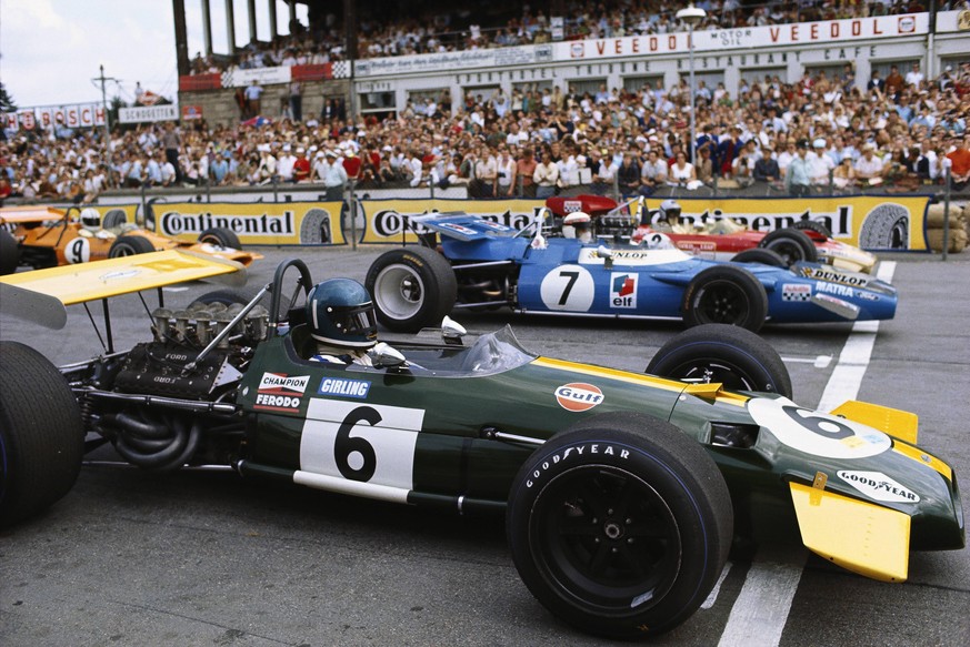 1969 German GP NüRBURGRING, GERMANY - AUGUST 03: Jacky Ickx, Brabham BT26A Ford, prepares for the start alongside Jackie Stewart, Matra MS80 Ford and Jochen Rindt, Lotus 49B Ford, on the front row of  ...