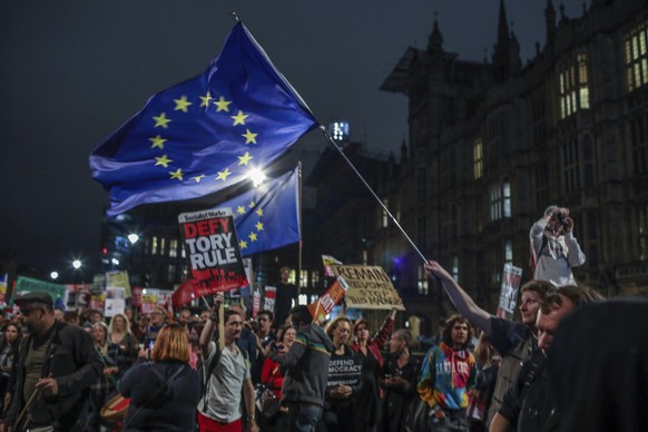 Protesters outside the House of Commons, London, Tuesday, Sept. 3, 2019. British Prime Minister Boris Johnson suffered key defections from his party Tuesday, losing a working majority in Parliament an ...