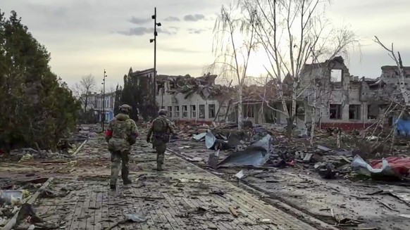 FILE - In this photo taken from video distributed by the Russian Defense Ministry Press Service on Thursday, March 13, 2025, Russian soldiers patrol an area in Sudzha, in the Kursk region of Russia, a ...