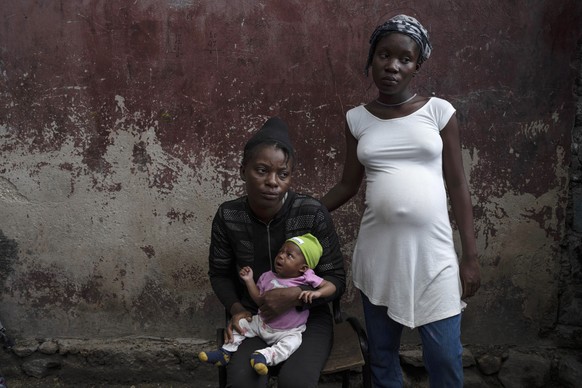 Januelle Datka, her baby girl Princess and her 15-year-old daughter Titti, pose for a photo at a makeshift shelter in Jean-Kere Almicar&#039;s front yard, in Port-au-Prince, Haiti, Sunday, June 4, 202 ...