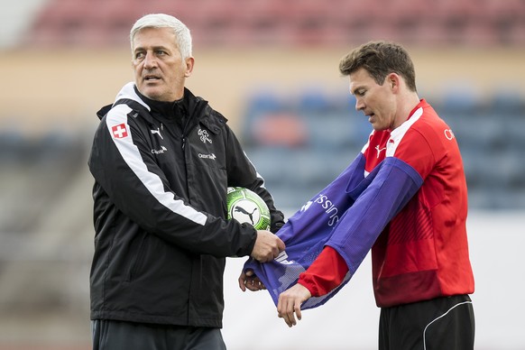 Swiss head coach Vladimir Petkovic, left, reacts next to Swiss defender Stephan Lichtsteiner, right, during a training session of SwitzerlandÕs soccer national team, at the stade Olympique de la Ponta ...