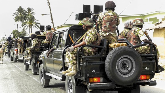 epa04678488 A photograph made available on 25 March 2015 shows the Nigerian military on patrol after flushing out Boko Haram Islamic militants from Michika, North East Nigeria, 19 March 2015. The Nige ...