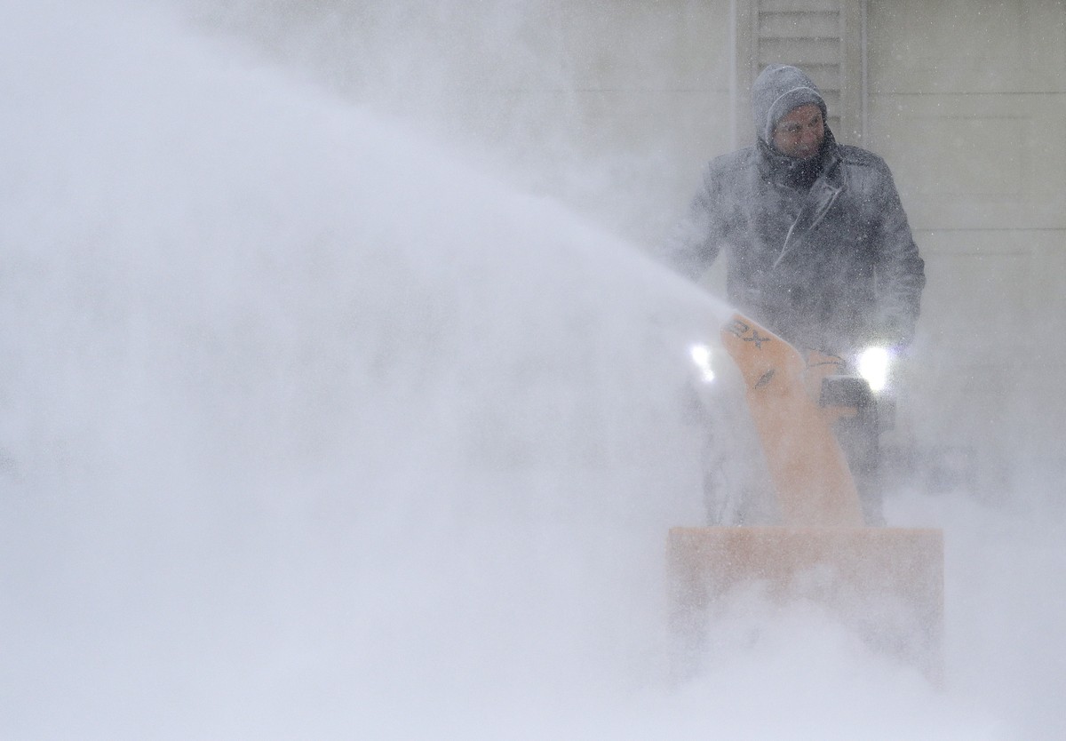 David Liebhard fights windy conditions as he snow blows his driveway Monday, Jan. 28, 2019, in Appleton, Wis. Heavy snow and gusting winds created blizzard-like conditions Monday across the Upper Midw ...