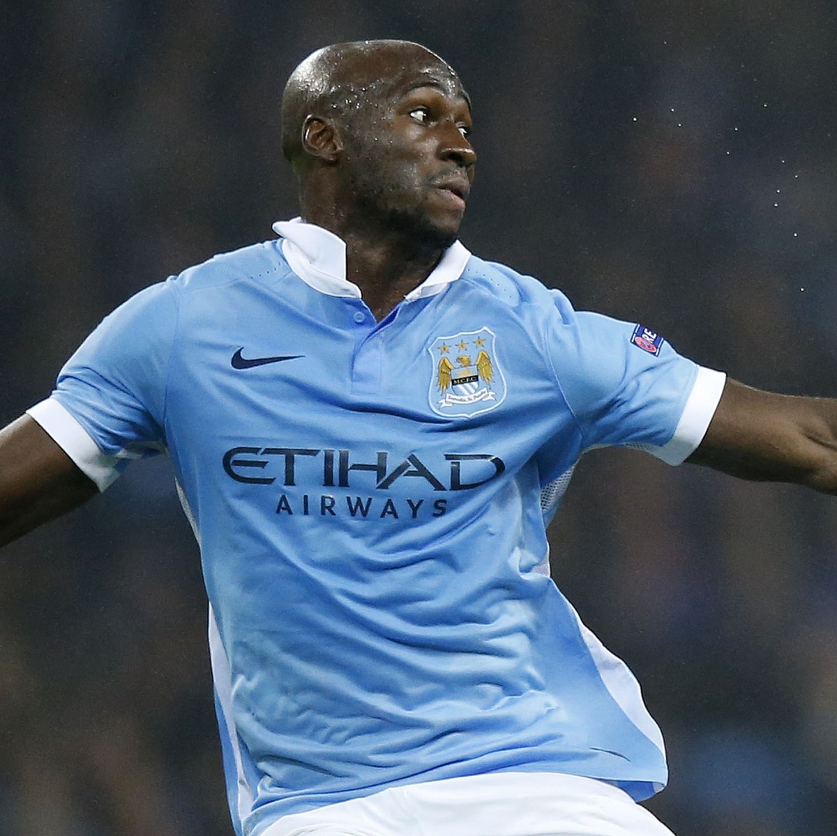 Manchester City's Eliaquim Mangala, left, and Sevilla's Vitolo fight for the ball during the Champions League Group D soccer match between Manchester City and Sevilla at the Etihad Stadium i ...