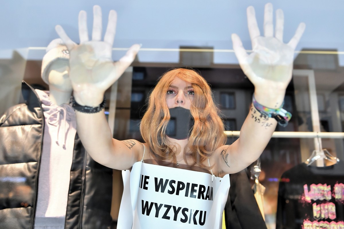 epaselect epa08846084 Extinction Rebellion Wroclaw activist, covered with placard 'I do not support exploitation' during the 'Naked protest on Black Friday' in a store in Wroclaw,  ...