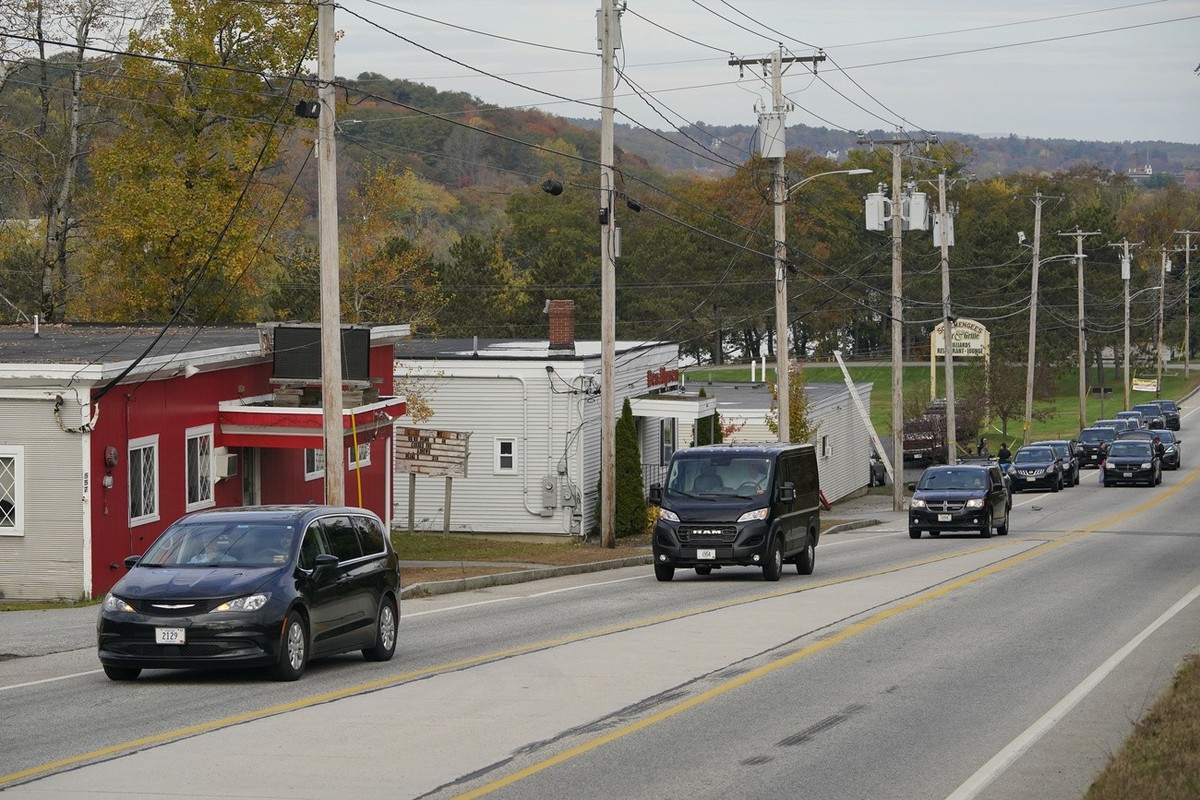 Three vehicles transport bodies from Schemengees Bar and Grille, Thursday, Oct. 26, 2023, in Lewiston, Maine. The restaurant was the site of one of the two mass shootings in Lewiston on Wednesday. (AP ...