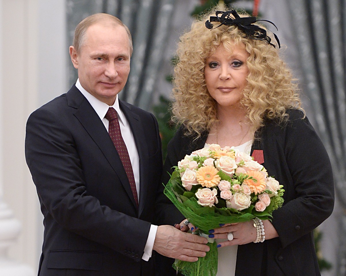 FILE - Russian President Vladimir Putin, left, and Russian pop singer Alla Pugacheva pose for a photo during an awards ceremony in Moscow's Kremlin in Moscow, Russia, Monday, Dec. 22, 2014. Iconi ...