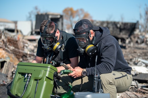 In this photo provided by U.S. Air National Guard, members of the Kentucky National Guard&#039;s 41st Civil Support Team use a portable gas chromatograph mass spectrometer in o test for airborne toxic ...