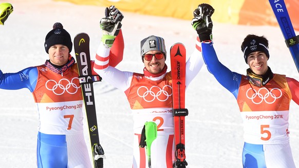 epa06519937 Gold medal winner Marcel Hirscher (C) of Austria is flanked by silver medalist Alexis Pinturault (L) of France and bronze winner Victor Muffat-Jeandet of France after the Men&#039;s Alpine ...