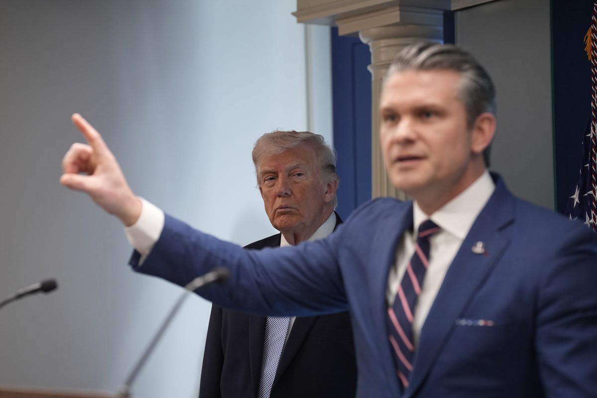 epa12872324 US President Donald J Trump (L) looks on as Secretary of Defense Pete Hegseth speaks during a media briefing on Iran from the James S Brady Press Briefing Room of the White House in Washin ...