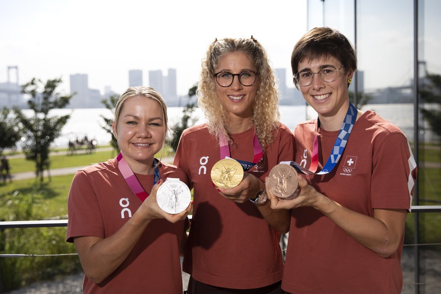 Mountainbike silver medalist Sina Frei, gold medalist Jolanda Neff and bronze medalist Linda Indergand of Switzerland, from left, pose with their medals at the 2020 Tokyo Summer Olympics in Tokyo, Jap ...